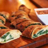 Spinach Stromboli · Provolone cheese and spinach. Served with a side of marinara.