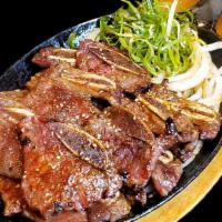 E 7. La Galbi 갈비 · Marinated prime ribs grilled in house special sauce. Beef on the bone. Served with side of w...