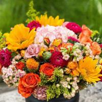 Orange Scented · Combination of bright orange roses, sunflowers and soft pink hydrangea.