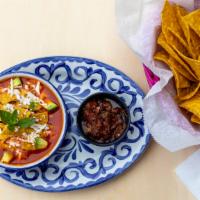 Chicken Tortilla Soup · Mexican soup with grilled chicken, crispy tortilla strips, avocado, Mexican rice and Cotija ...