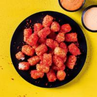 Blazed Cheesy Tots · Perfectly crispy, seasoned potato tots topped with Hot Cheetos dust and served with a side o...