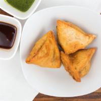 Samosa · Samosa, is a traditional Indian snack made with pastry dough stuffed with a savory filling s...