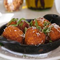 Risotto Balls · Fried risotto balls stuffed with mozzarella cheese and mushrooms, served with marinara sauce.
