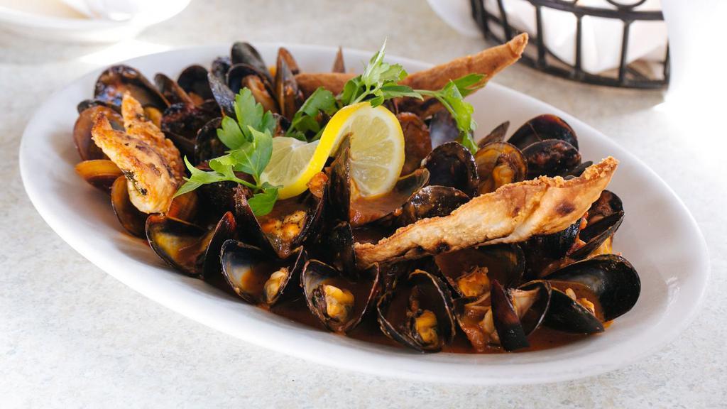 Mussels · PEI mussels sautéed in olive oil, garlic and white wine, choice of red or white sauce.
