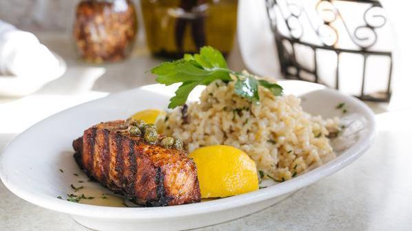 Atlantic Salmon · Simply grilled, topped with lemon, olive oil and capers, served with mushroom risotto.