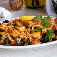 Fra Diavolo Pasta · Shrimp, calamari, salmon, chopped clams and mussels in a spicy marinara sauce over linguini ...