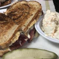 Reuben Sandwich · Corned beef, swiss, Russian dressing, and sauerkraut grilled on your choice of bread.