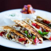 Quesadilla · Flour tortilla filled with grilled peppers and onions, served with sour cream pico de gallo.