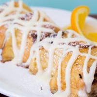 Cinnamon Bun French Toast · Two big cinnamon buns sliced and dipped in our vanilla egg batter and grilled, topped with c...