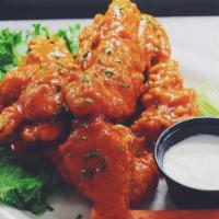 Boneless Buffalo Chicken · 4 chicken fingers tossed in homemade buffalo sauce, served with blue cheese, celery and carr...