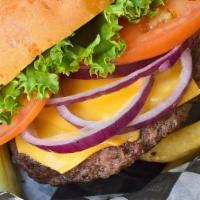 Deluxe Burger · 8oz fresh ground sirloin cooked to your liking, topped with American, lettuce, tomato, and o...