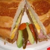 Torta Cubana · Comes with sausage, bacon, jam, chorizo, egg, beans, lettuce, pico de gallo, jalapeno, avoca...