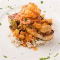 Grilled Cajun Swordfish  · with shrimp, sundried tomatoes and mushrooms in a basil wine herbed sauce over risotto.