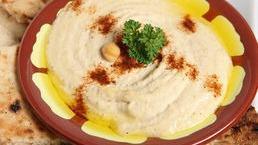 Hummus · Classic Mediterranean dip with chickpeas, tahini and garlic. Served with Homemade pita bread.