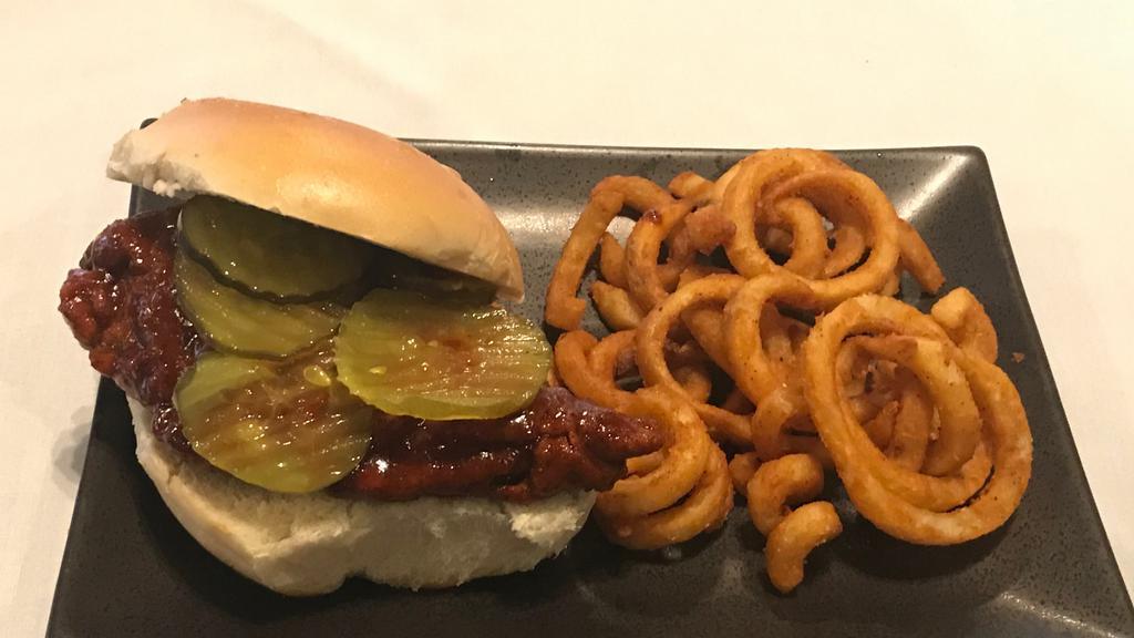 Nashville Hot Chicken Sandwich · Fried chicken with Nashville hot sauce topped with ranch & pickles on a brioche bun. Served with curly fries.