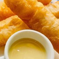 Thai Donuts · Crispy strips of fried dough served with sweetened condensed milk