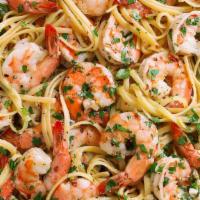 Shrimp Scampi · Tender shrimp gently sauteed in garlic oil and butter served over a bed of linguini.