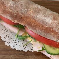 Turkey & Swiss · Freshly baked hoagie roll with turkey, melted Swiss cheese, arugula, tomato, cucumber, and D...