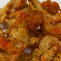 Crawfish Popcorn Caesar Salad · Fried crawfish tails over caesar with creole mustard