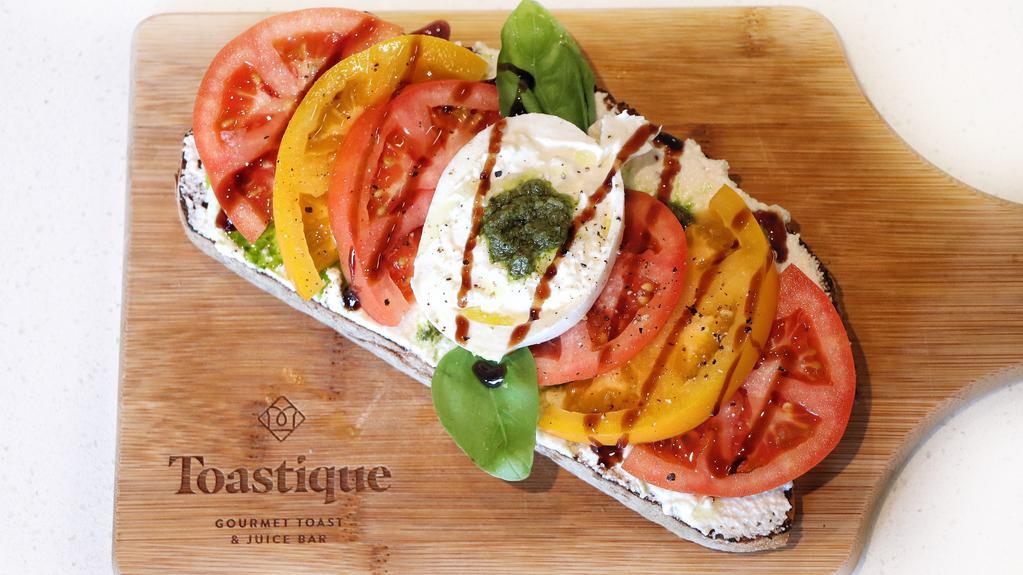 Tomato Burrata · Herbed ricotta, pesto, tomatoes, burrata, basil, olive oil, balsamic glaze on rustico toast.