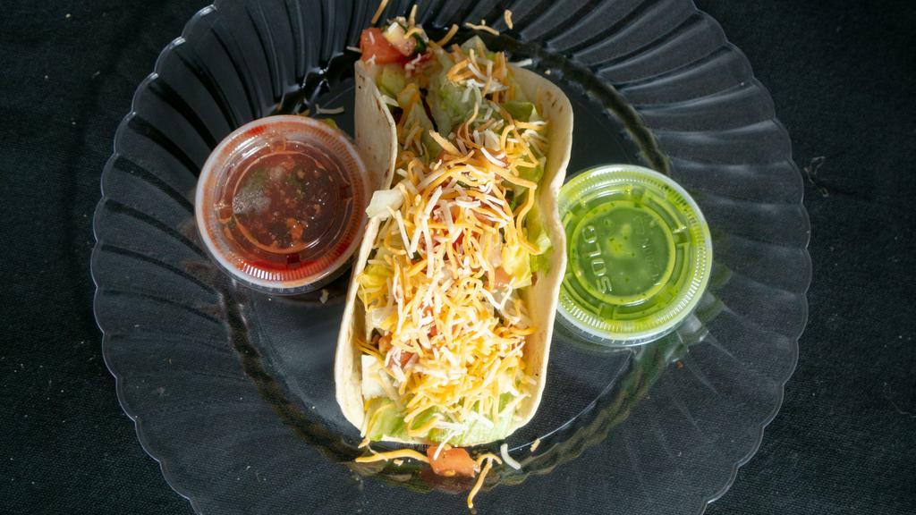 Steak Taco · Served with your choice of flour corn or crispy tortillas with lettuce cheese and pico de gallo.