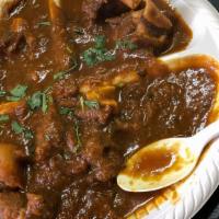 Goat Curry · Goat meat marinated and cooked with herbs and spices