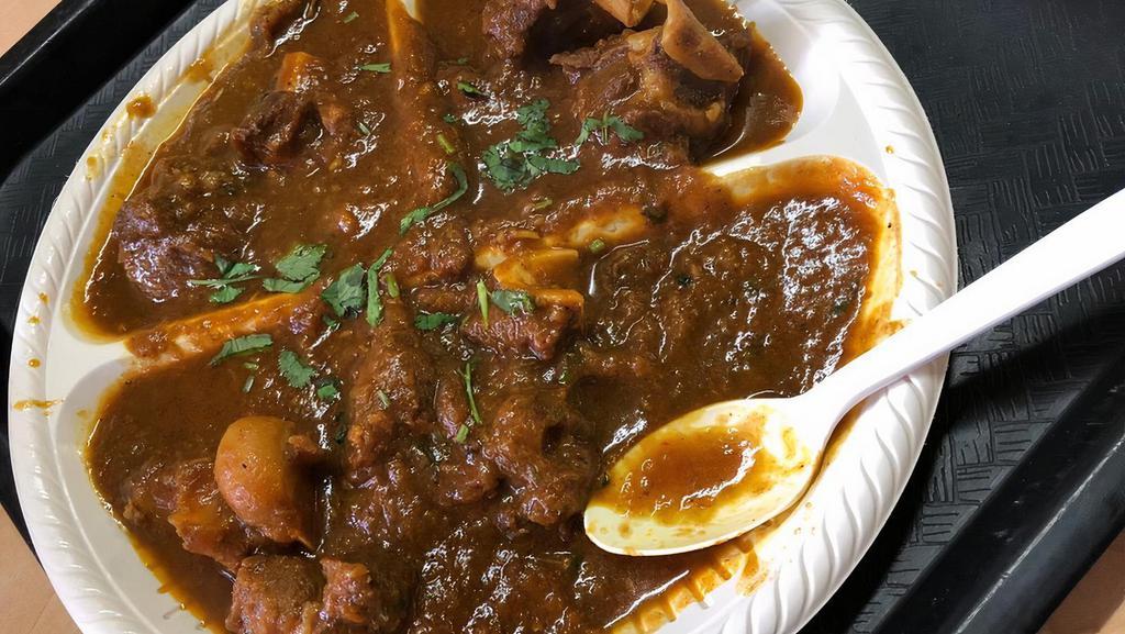 Goat Curry · Goat meat marinated and cooked with herbs and spices