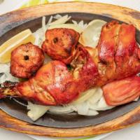 Tandoori Chicken · Half of chicken marinated overnight in yogurt,garlic,ginger,herbs and spices cooked in charc...