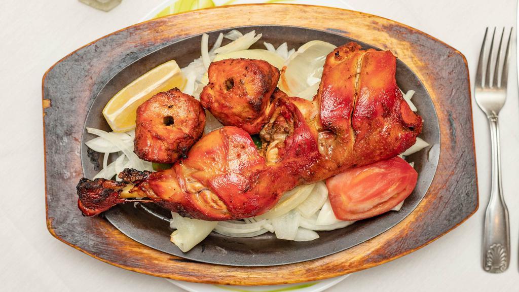 Tandoori Chicken · Half of chicken marinated overnight in yogurt,garlic,ginger,herbs and spices cooked in charcoal clay-oven.
