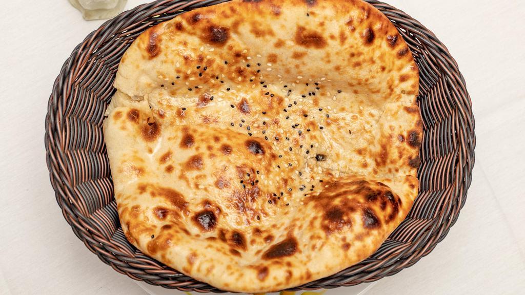 Garlic Naan · White Flour Bread Layered With Chopped Garlic Bread In A Flaming Charcoal Clay Oven.