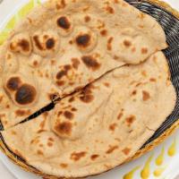 Roti · Made With Whole Wheat Flour Baked In Clay Oven.