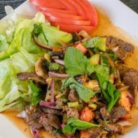 Yum Nua Salad · Hot & spicy. Grilled beef with a spicy sauce, onions, scallions, mushrooms, lemongrass, cila...