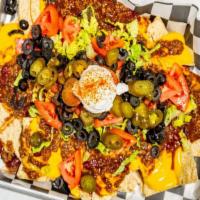 Boulevard Nachos · Nachos are served with chili, cheese, fresh Romaine, diced tomatoes, black olives, and jalap...