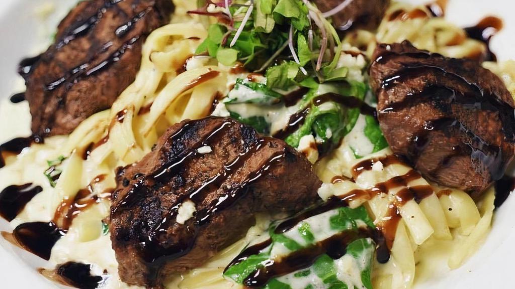Tips Gorgonzola · grilled beef tenderloin tips, house made alfredo sauce, fresh spinach, great hill bleu cheese, fettuccine, balsamic drizzle