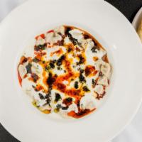 Manti · Turkish dumplings stuffed with a ground beef and lamb mix. Served with homemade yogurt, red ...