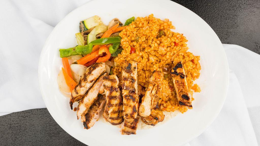 Char-Grilled Chicken Thighs · Marinated, seasoned grilled chicken served with bulgur rice, onion parsley salad, antep salad and sautéed vegetables.
