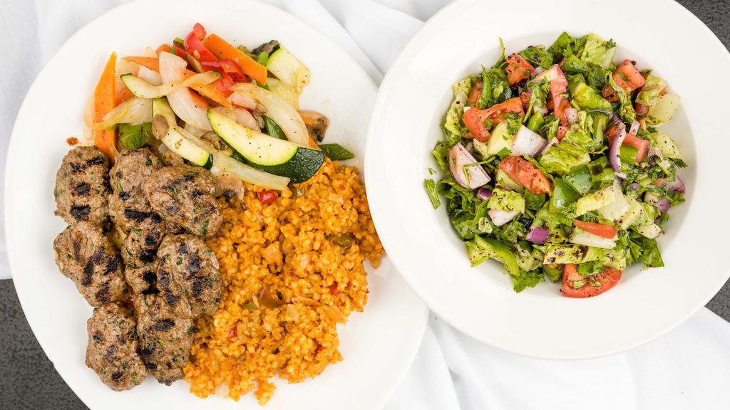 Kasap Kofte · Ground beef and lamb mix patties marinated with fresh parsley and Turkish spices. Charbroiled to perfection. Served with bulgur rice, onion salad, Antep salad and sautéed vegetables.