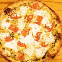 The Mediterranean · Our homemade pesto sauce topped with fresh tomato, roasted garlic, creamy NY ricotta, and go...
