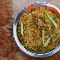 Chicken Biryani · Saffron flavored basmati rice cooked with boneless pieces of chicken, over low fire with Ind...