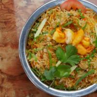 Shrimp Biryani · Saffron flavored basmati rice cooked with shrimp, over low fire with Indian herbs. Served wi...