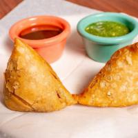 Vegetable Samosa · Two pieces. Fried crisp pockets filled with potatoes and green peas.