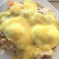 Crab Eggs Benedict · Creamy Crab & Tomato topped w/ poached eggs on English muffin and Hollandaise Sauce