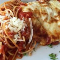 Chicken Parmesan · Breaded cutlet with tomato sauce, mozzarella cheese and spaghetti pasta.