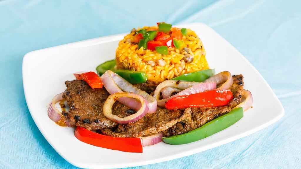 Steak & Onions · Skillet beef steak marinated and grilled in a delicious home made marinade served with sauteed onions. (Caribbean dish).