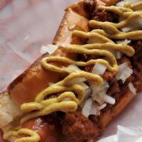 Norc Dog · dog with house made chili, raw onions, and yellow mustard