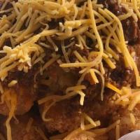 Tots-Coney · Topped with house made chili & shredded cheddar.