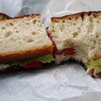 Mediterranean Sandwich · Grilled marinated chicken with crisp romaine lettuce, red onions, hummus and roasted red pep...