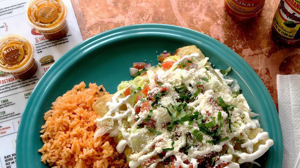 Enchiladas · Three fresh corn tortillas, choice of one filling. Salsa verde, topped with melted cheese served with rice, refried beans lettuce, pico and sour cream.