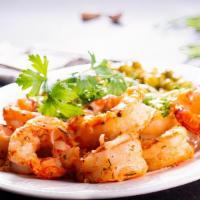 Sautéed Shrimp · Tender sautéed shrimp in a mild sauce on a bed of rice.