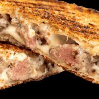 Filet Grilled Cheese · American cheese on white bread toasted on a panini press with filet mignon mixed in.